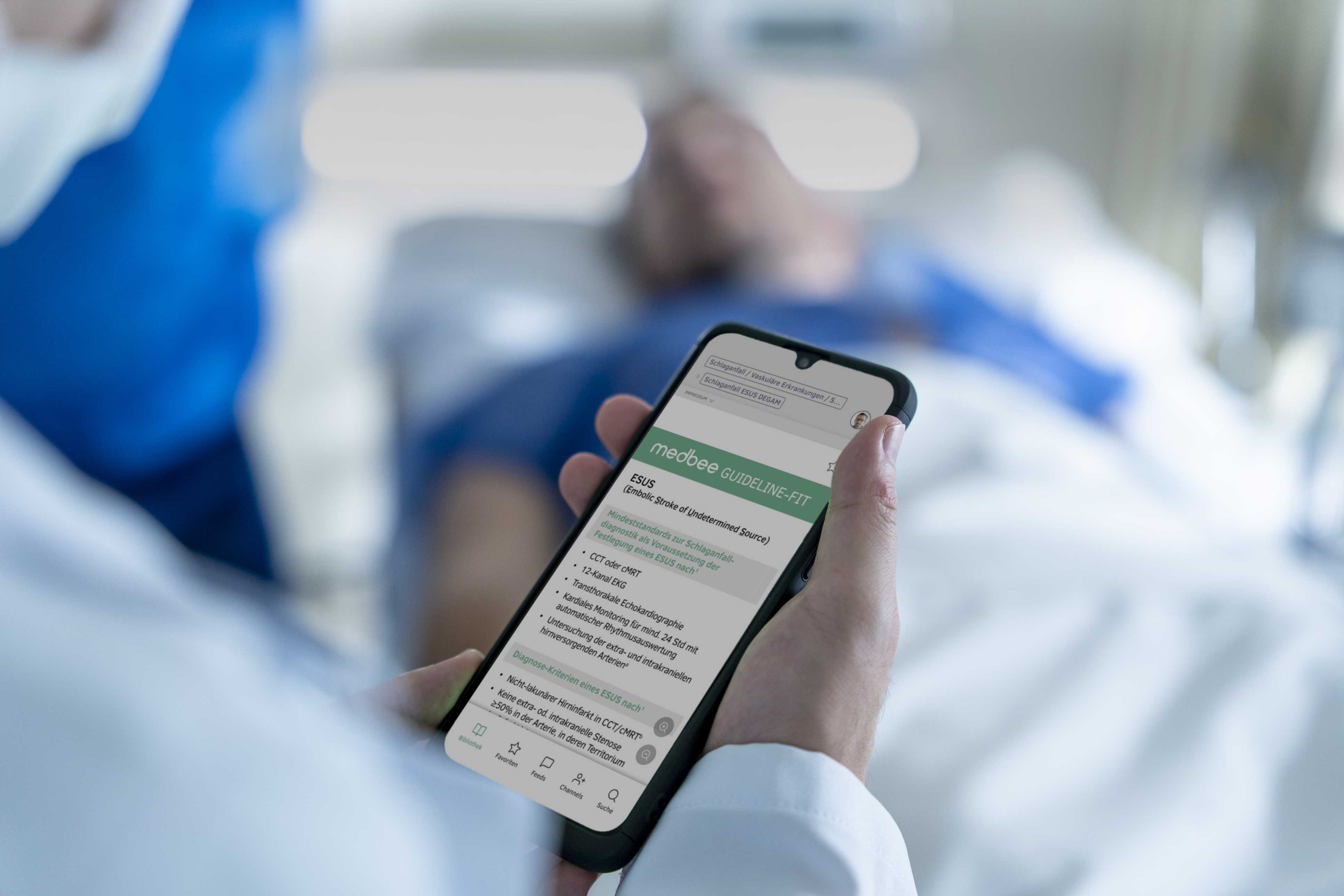 Inside hospital. Close-up of a doctor's hand holding a smartphone displaying screenshot of app.