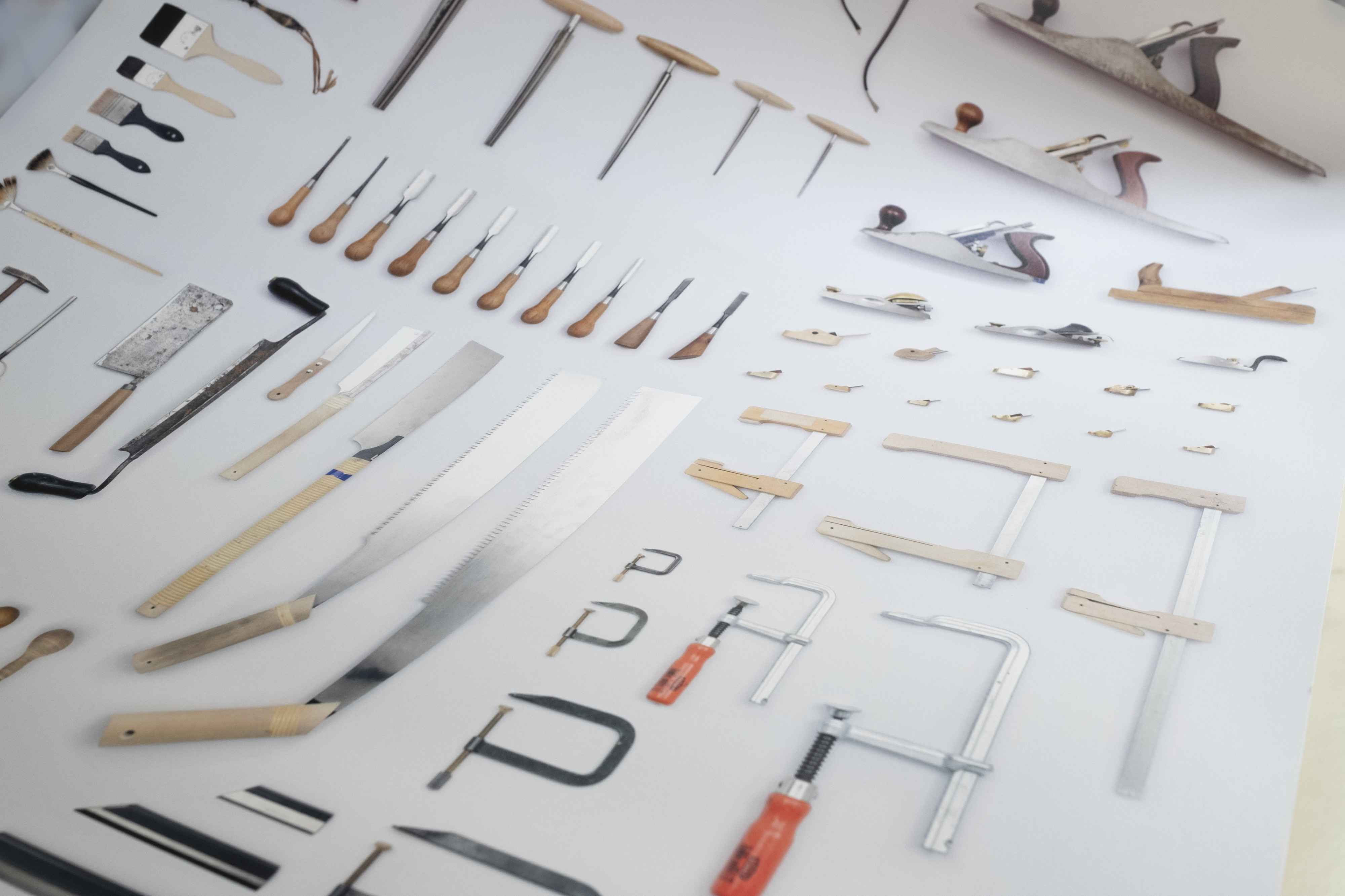 Close-up of poster. Arrangement of all tools from violin maker's workshop.