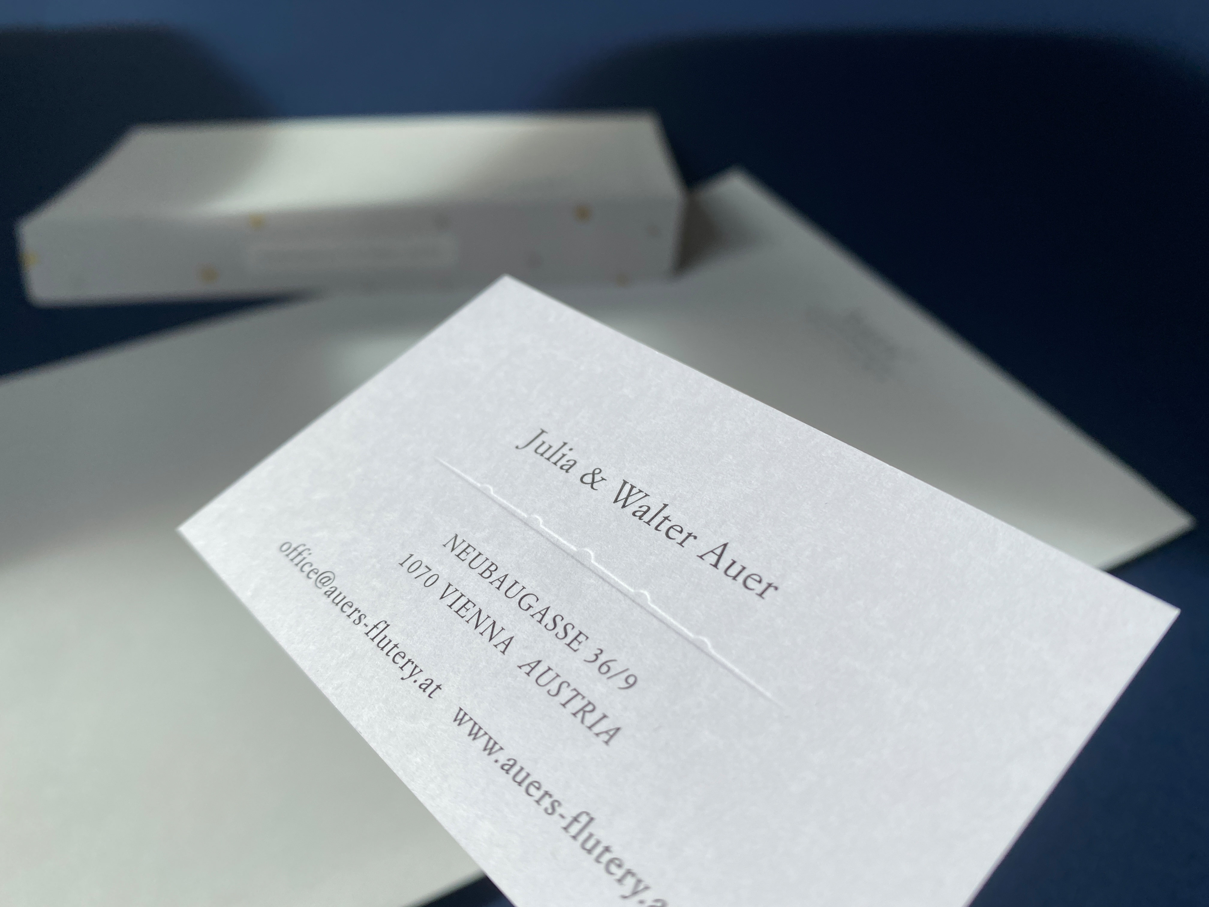 Detail shot of business card. Part of logo is embossed.