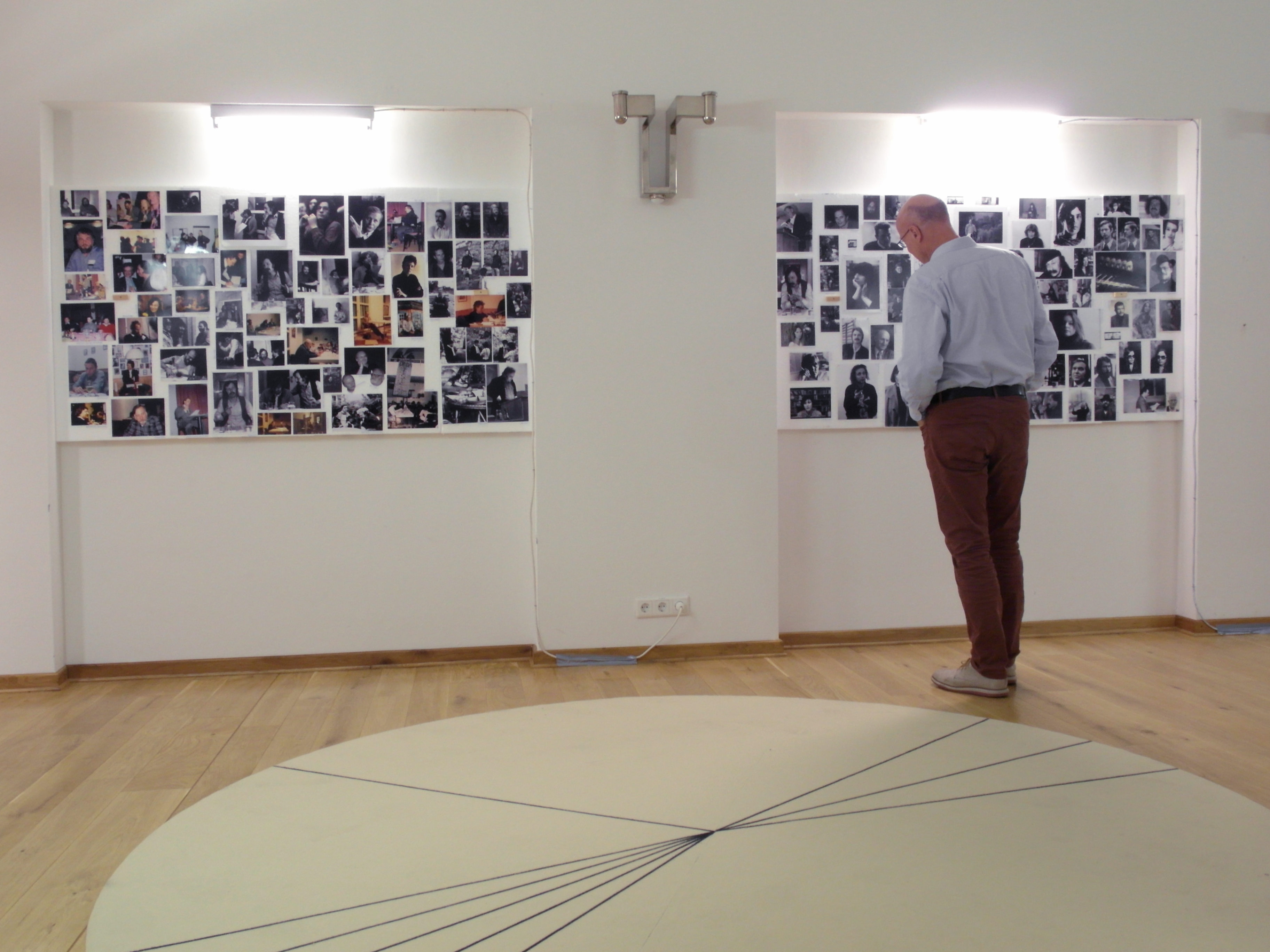 Visitor standing in front of photo pin-wall.