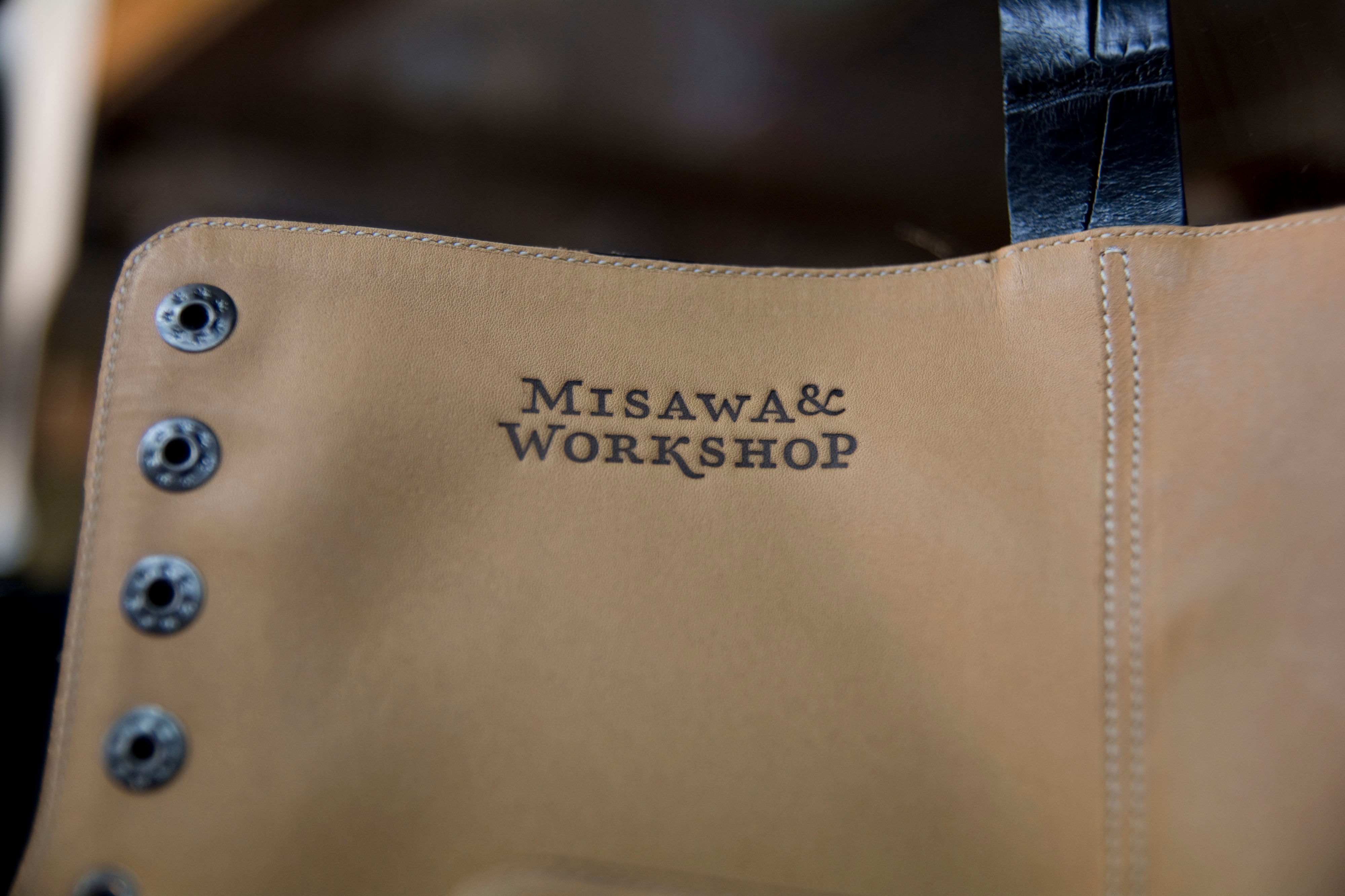 Close-up of shoe shaft. Brand stamped logo in leather.