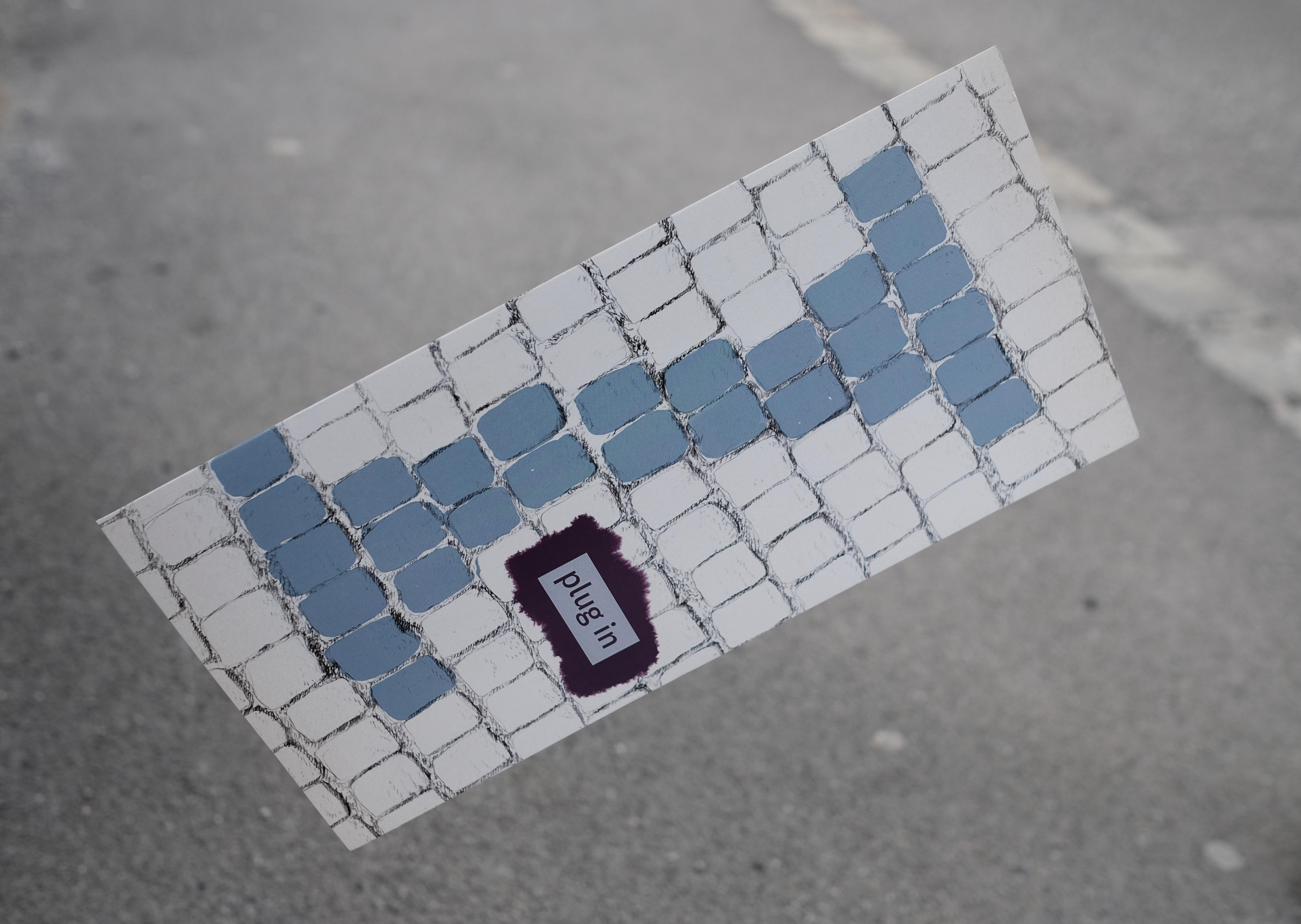 Cover folder: Illustrated cobblestone floor. Some coblestones coloured. Logo overlayed on right side.