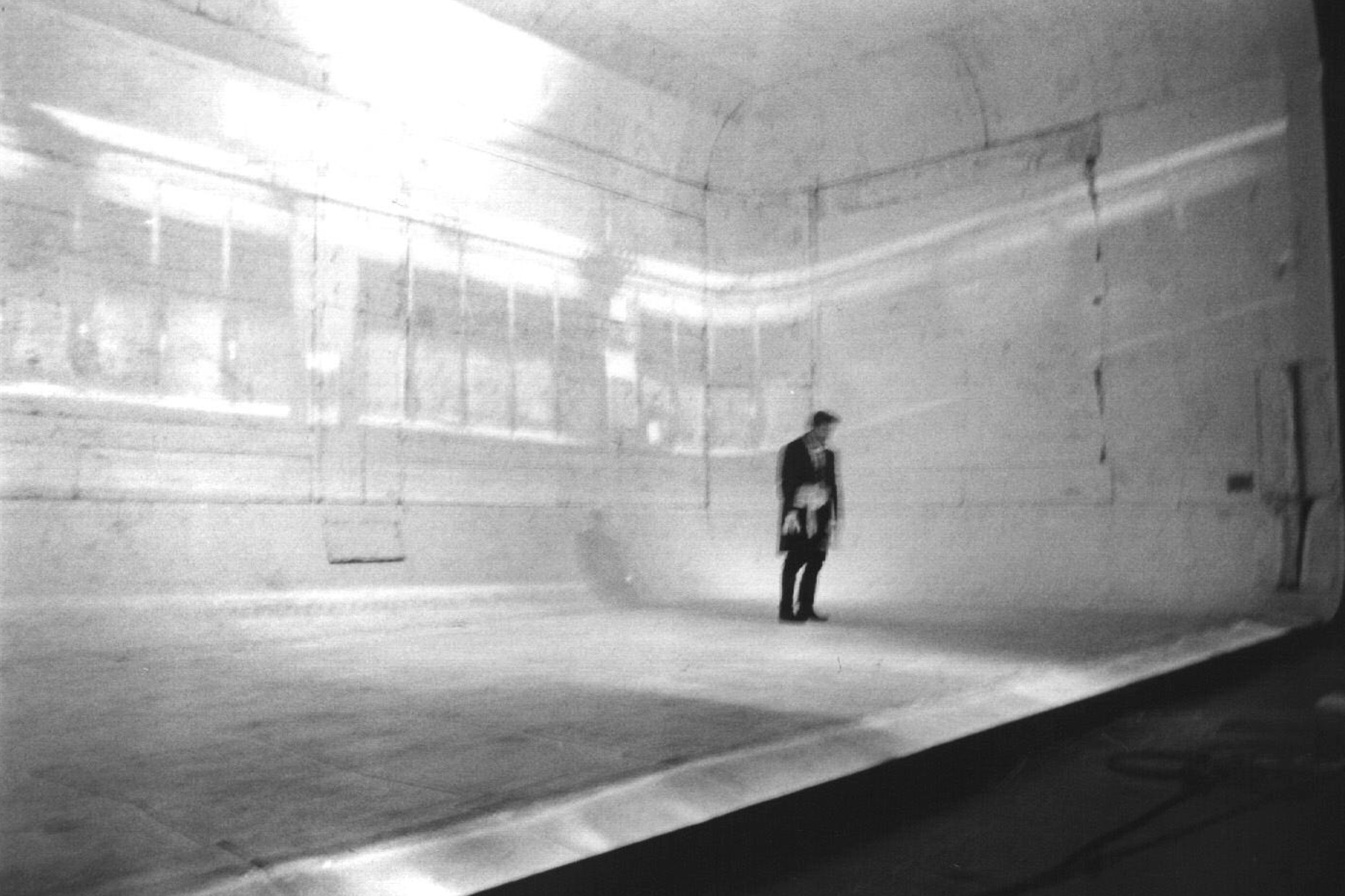 Blurry b/w photo of stage at theatre.