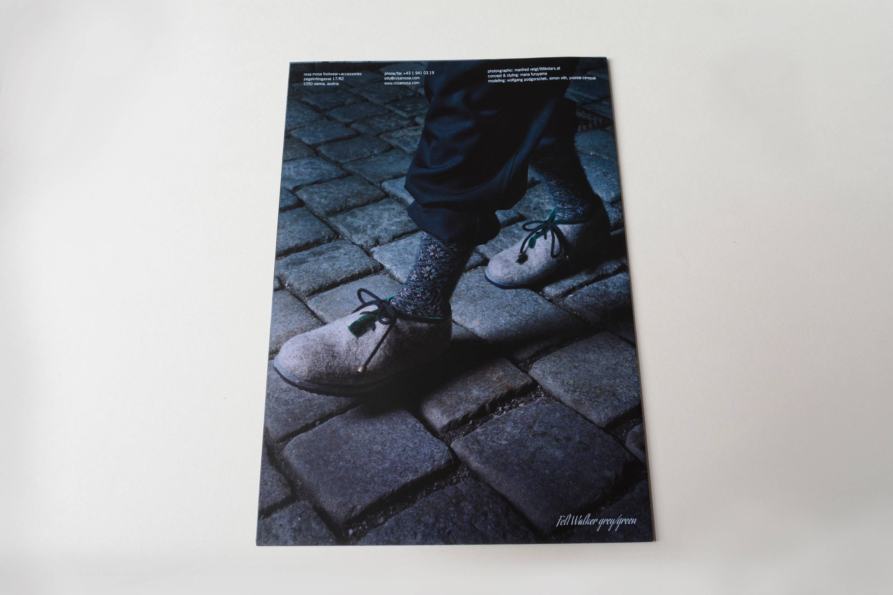 Cover back. Full-page close-up photo of feet in shoes walking on coblestone. Small text blocks overlayed at top.