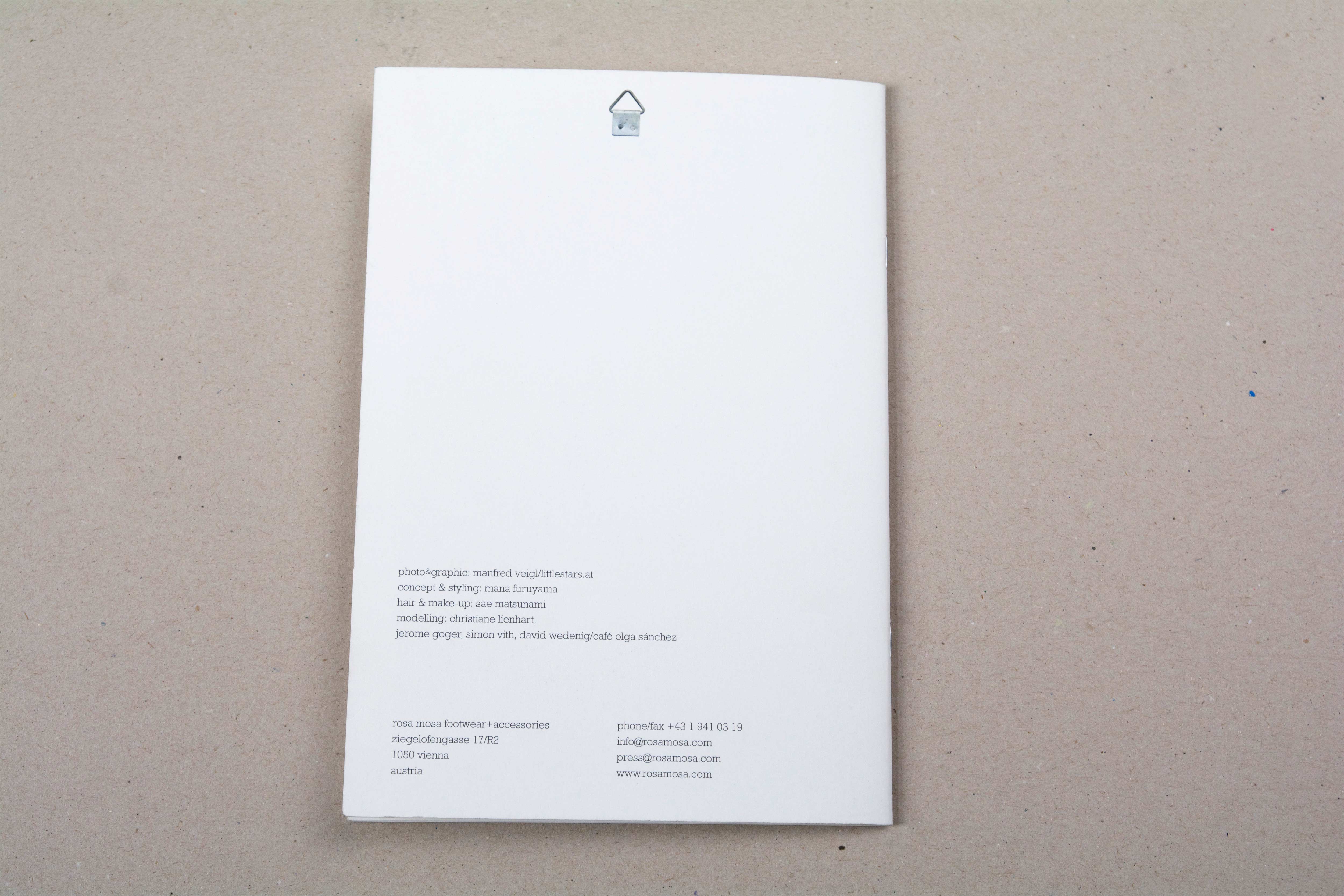 Cover back. Blank with block of texts at bottom. Small cropped image of a hook on top.