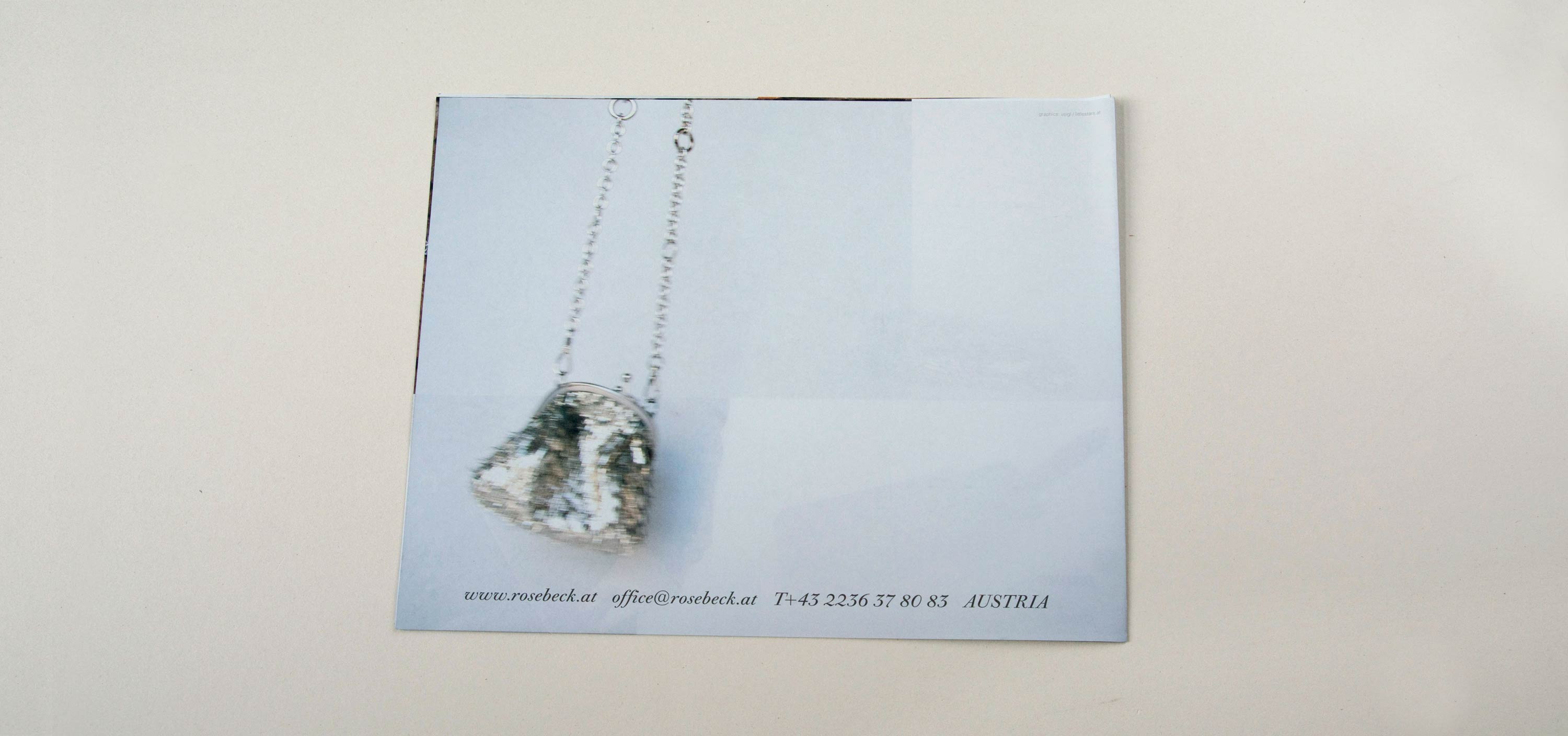Cover back. Blurry full-page photo of pouch hanging on chain. Row of text overlayed at bottom.