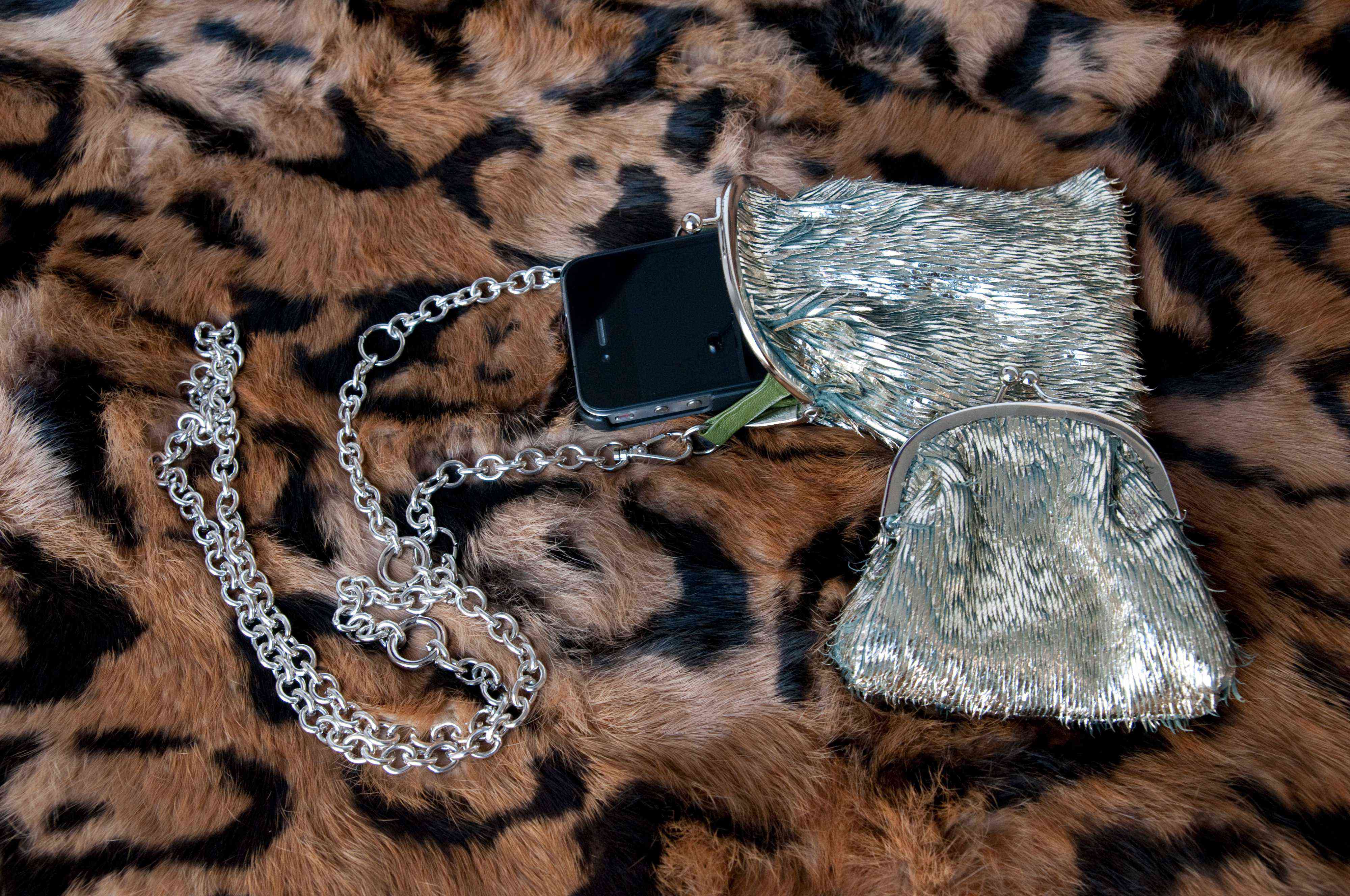 Smartphone half inside pouch placed on fabric.