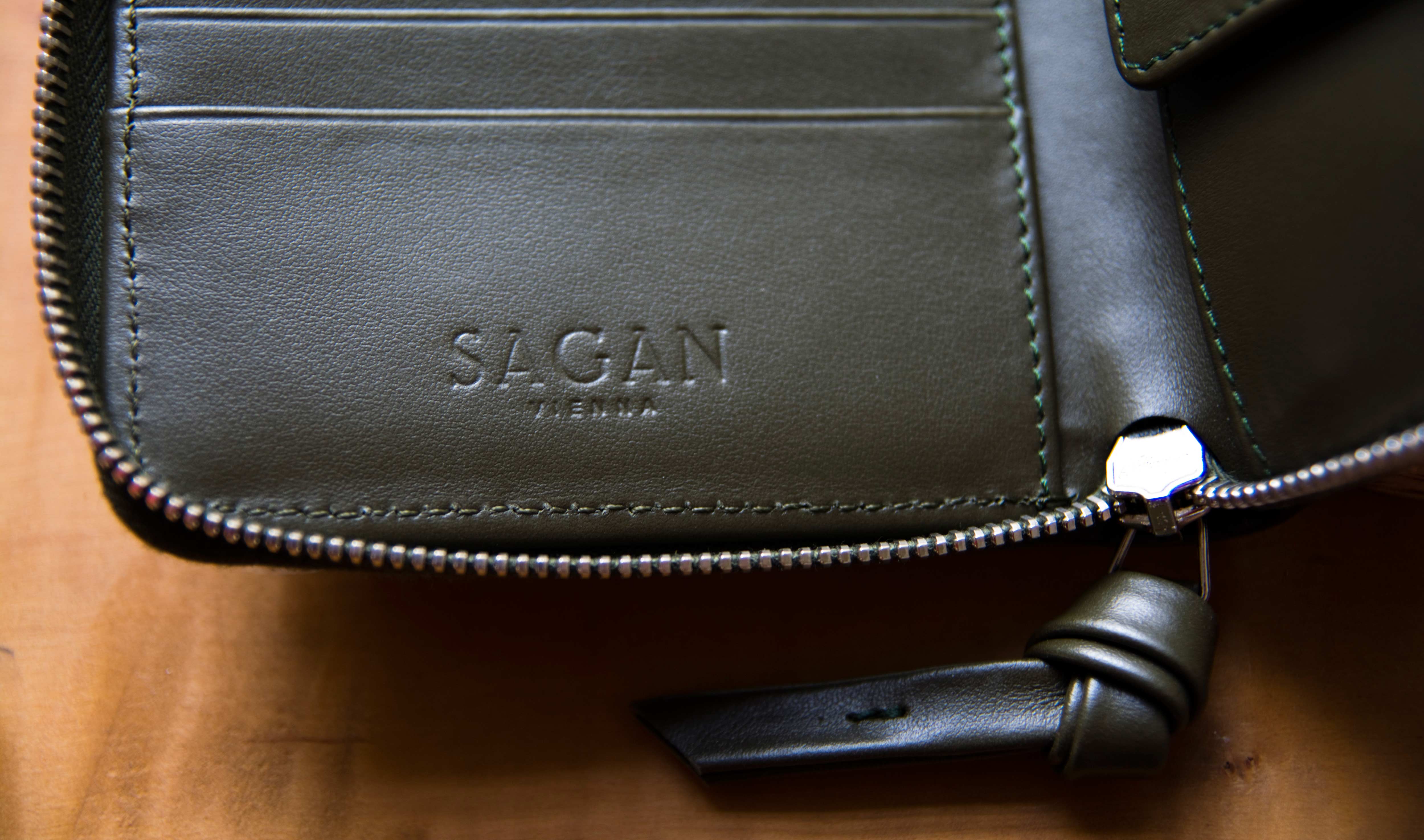 Close-up of inside of leather wallet. Punched Logo in leather.