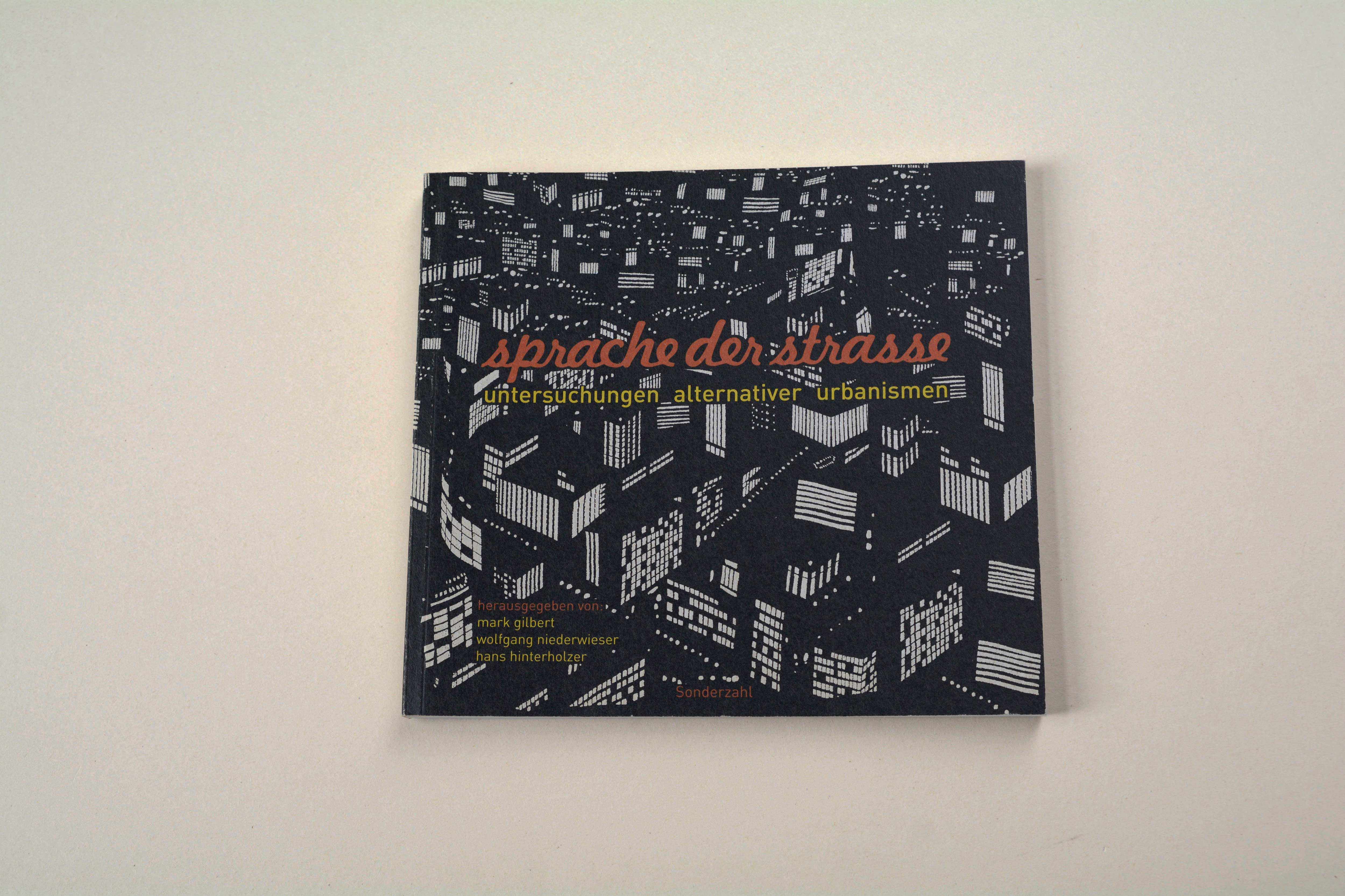 Brochure front cover. B/W illustration of city at night. Title in script font overlayed.