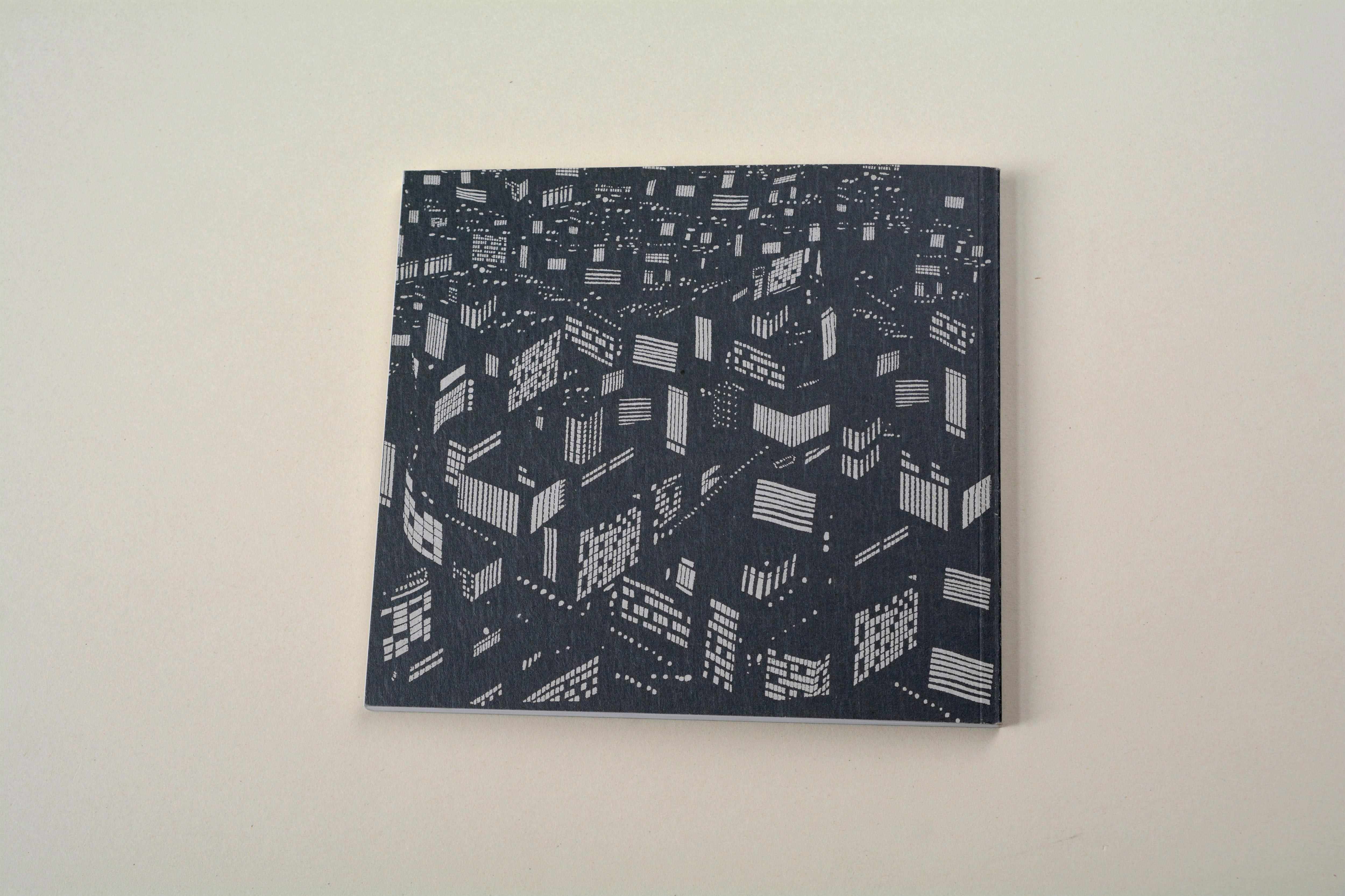 Back cover. B/W illustration of city at night.