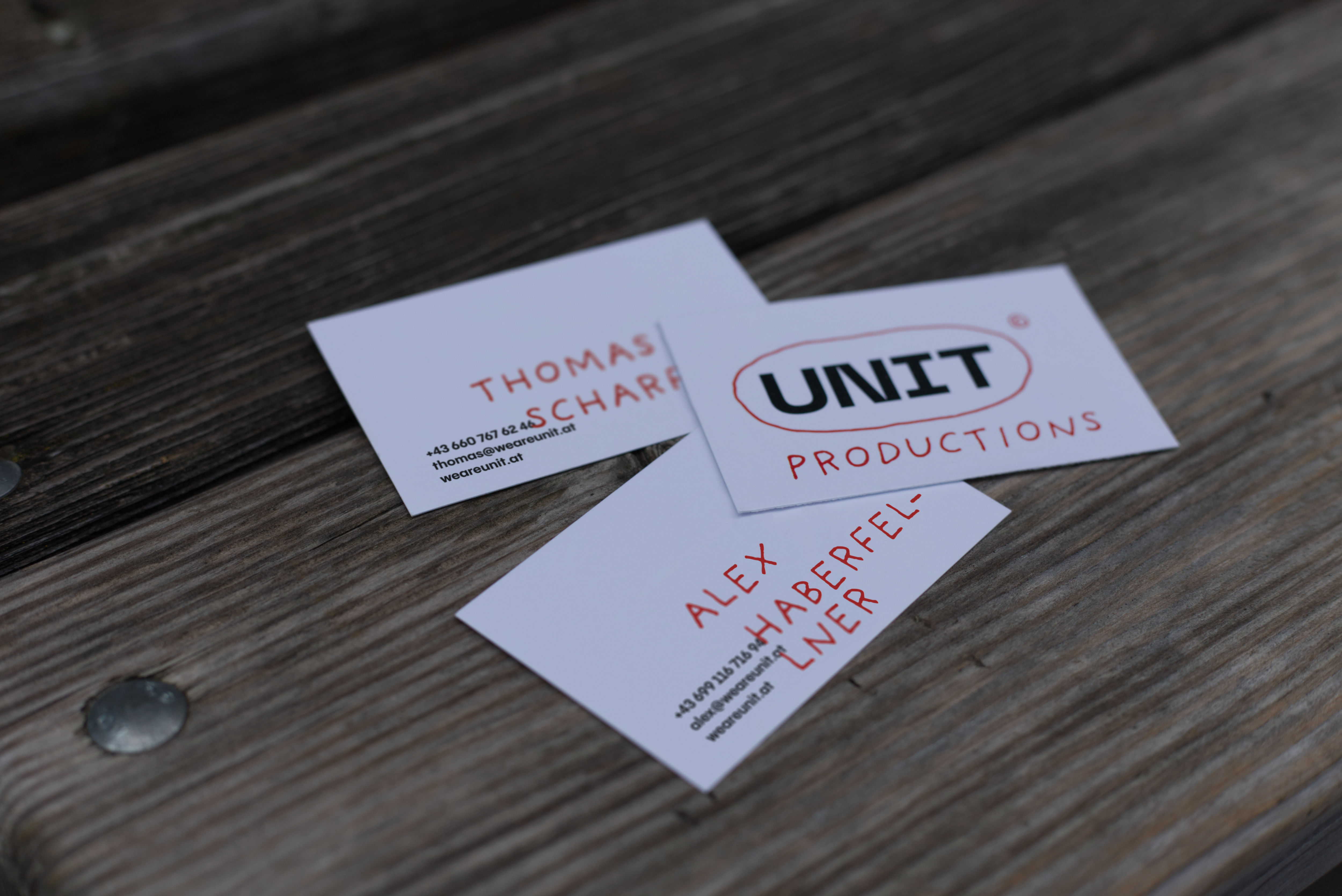 Set of business cards placed on bench in park.