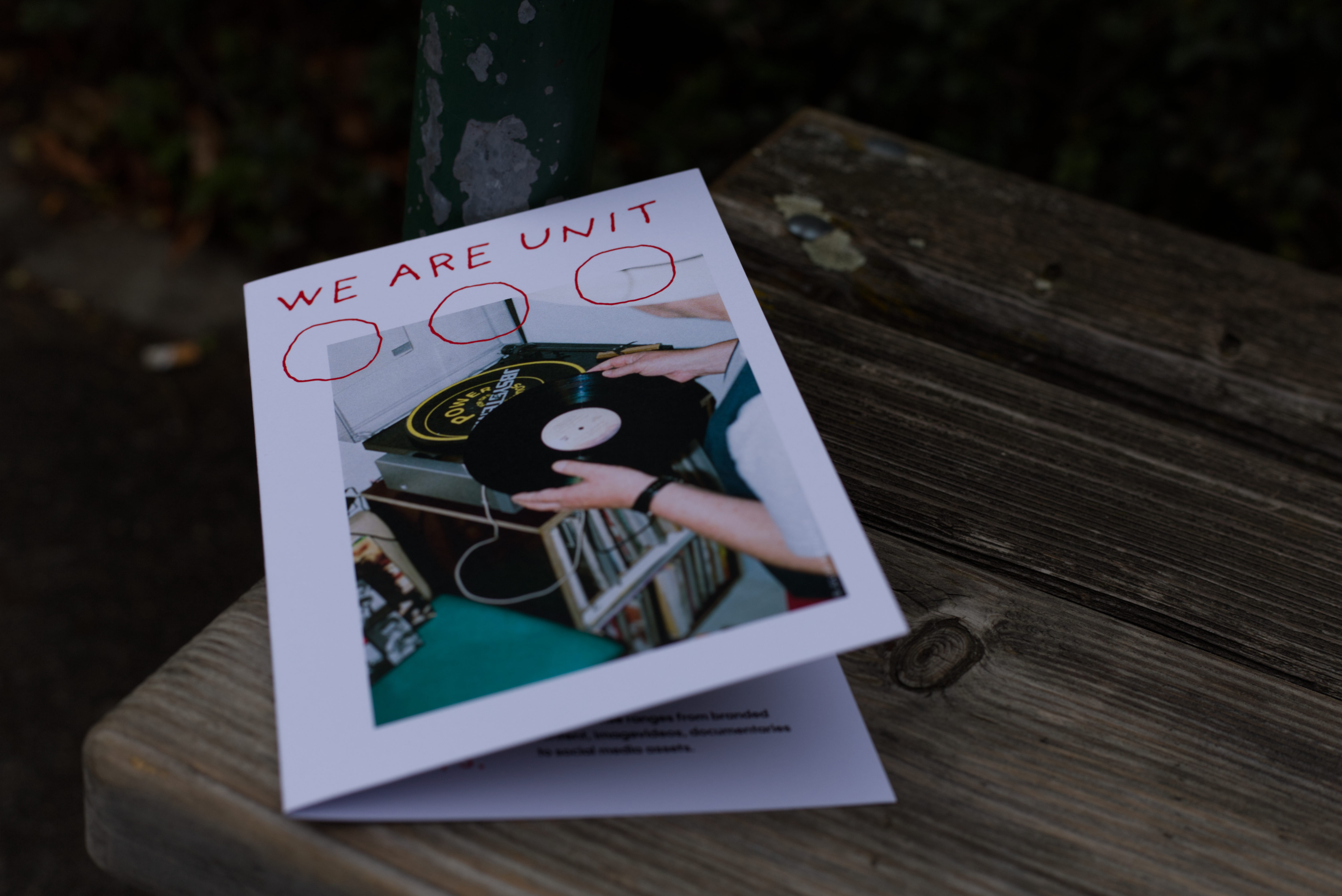 Folder placed on bench in park.