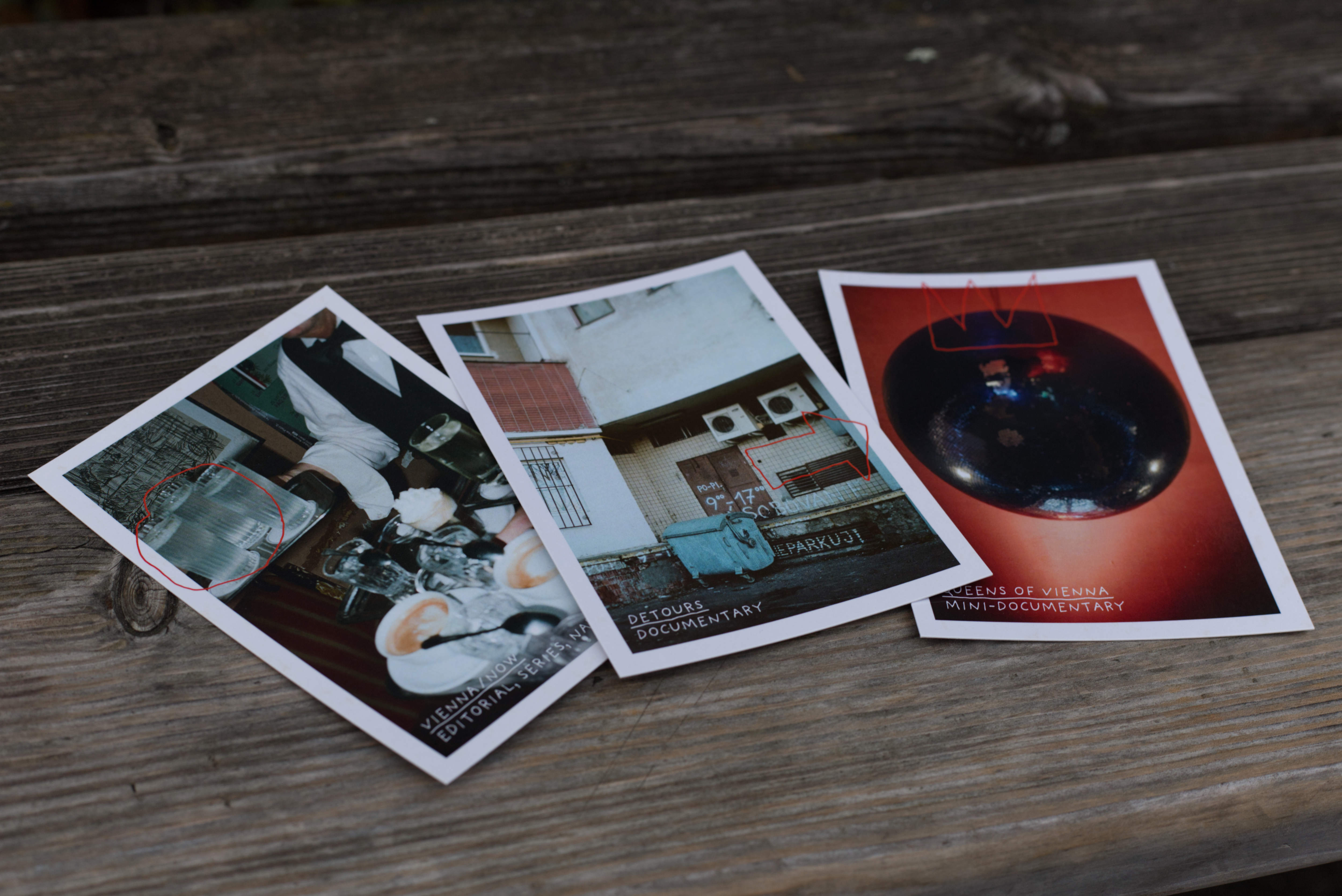 3 Postcards placed on bench in park.