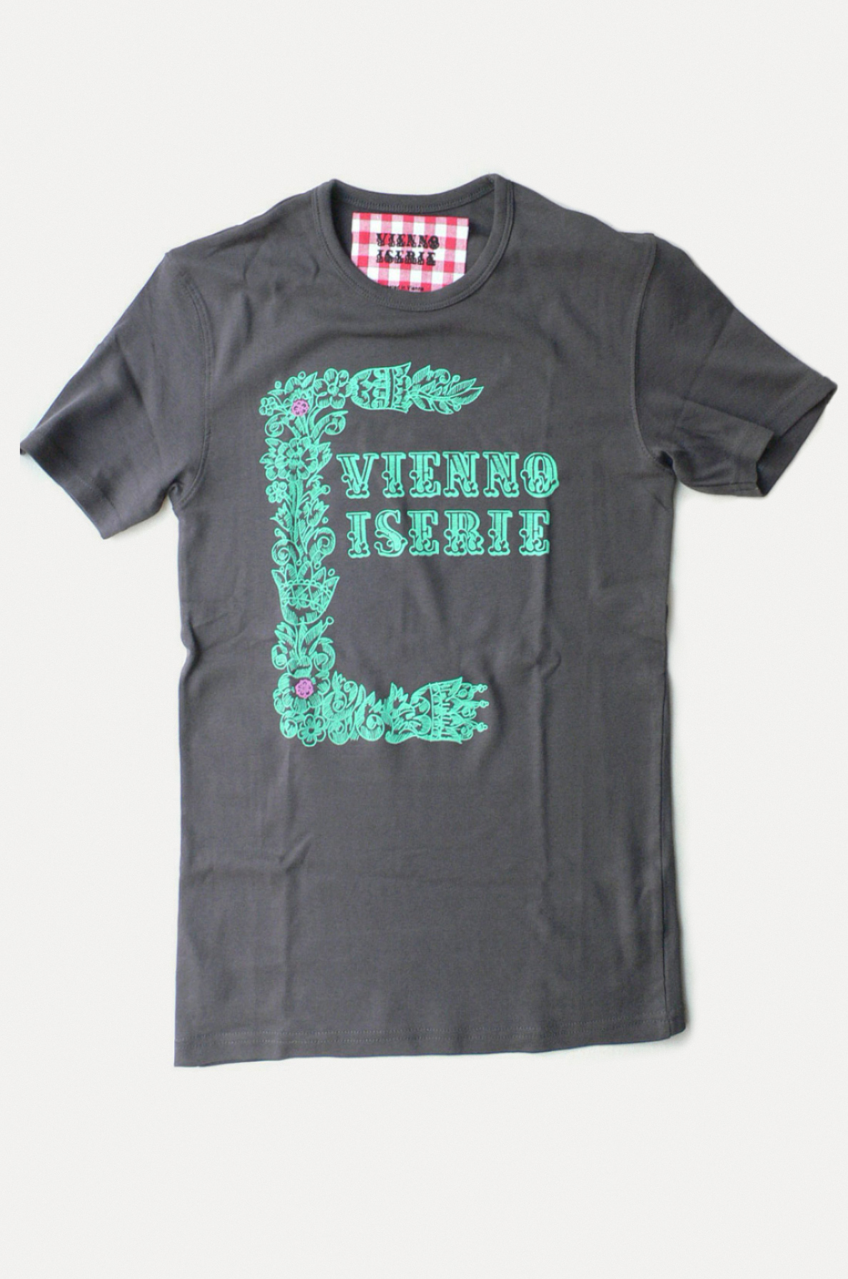 Dark grey t-shirt. Logo and decorative Elements in strong green colour printed on it.